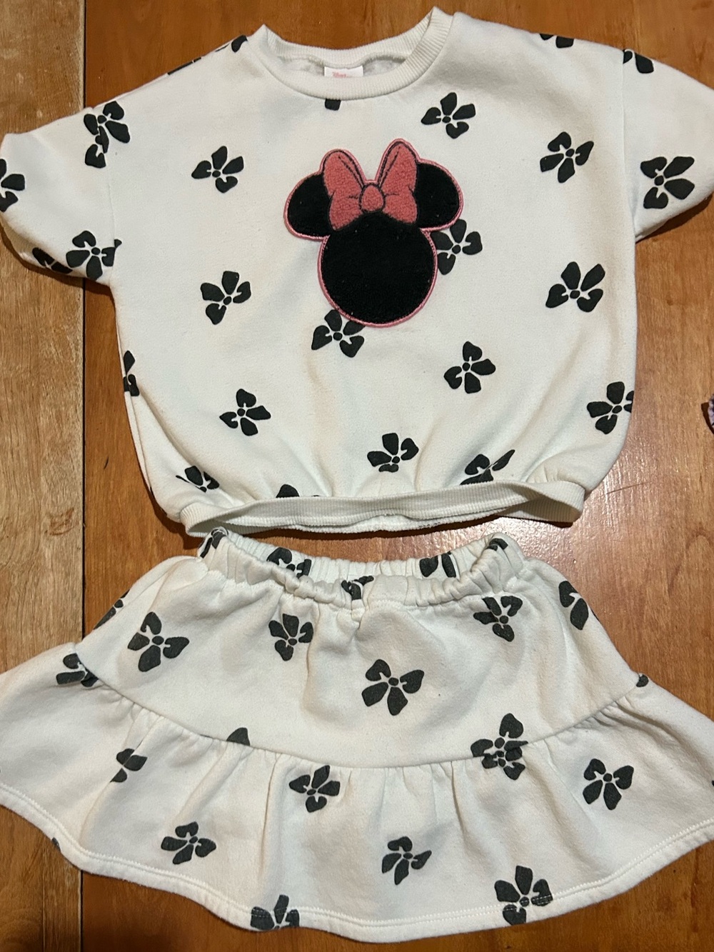 Cream Girls Two-Piece Skirt Set with Black Floral Print and Pink Bow Accent